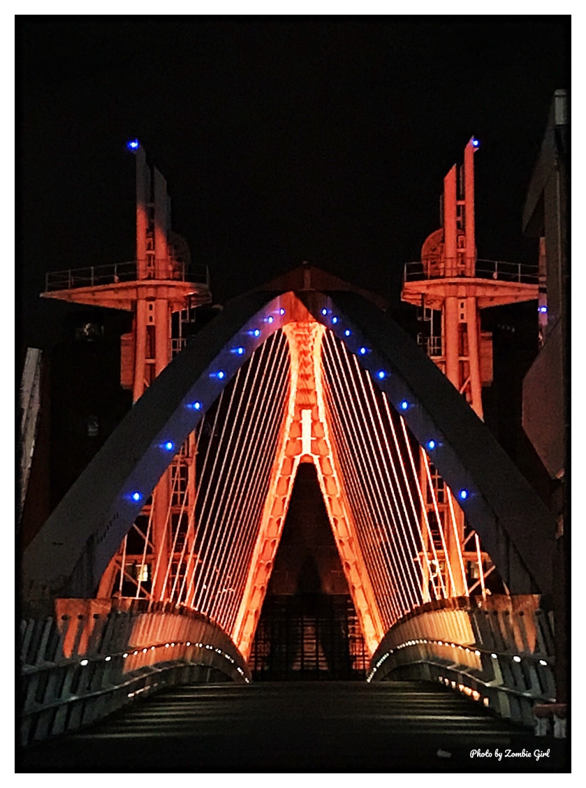 A bridge lit up at night gives a different perspective of a familiar place
